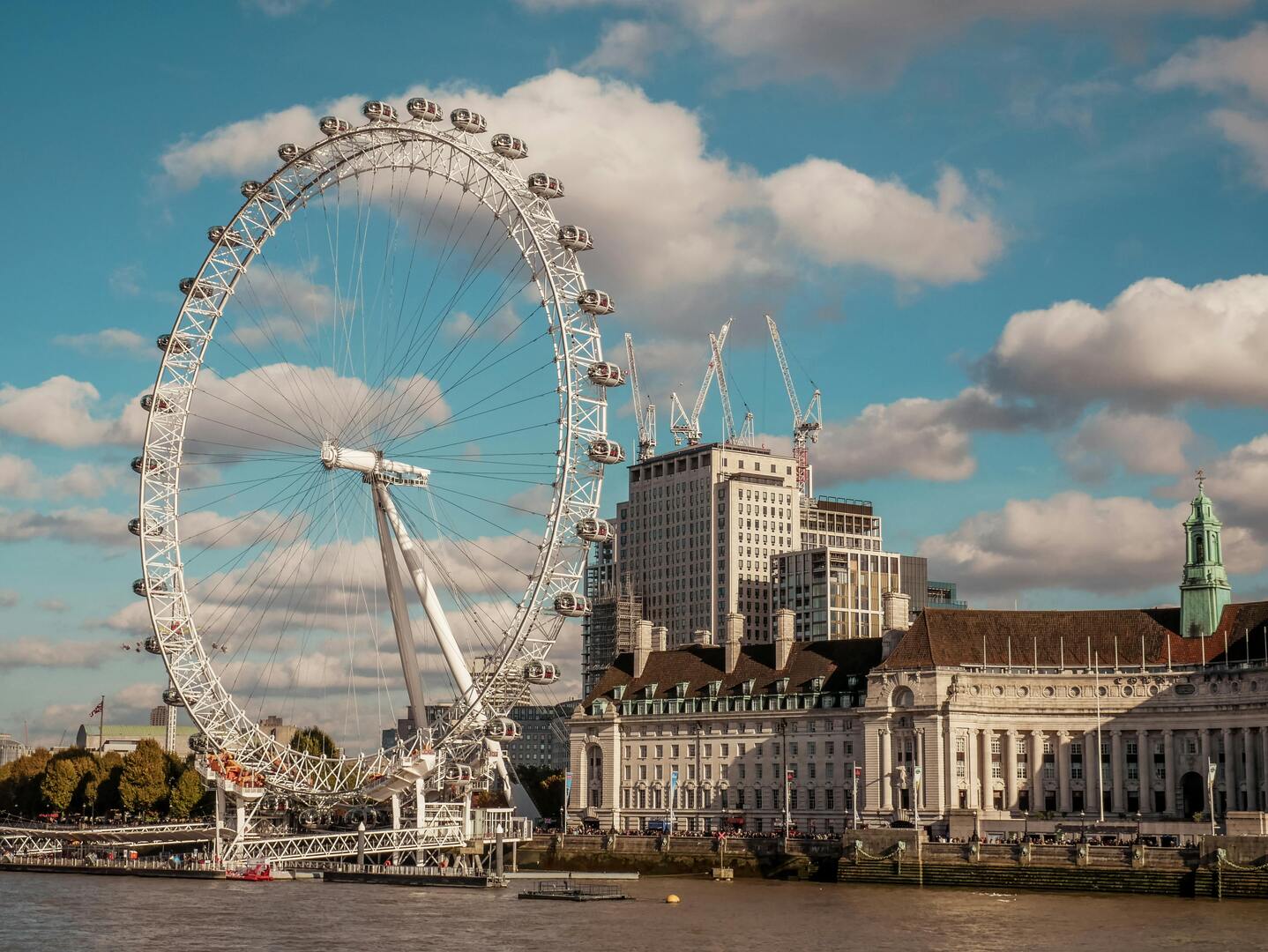 The London Eye observation wheel with pods overlooking the River Thames